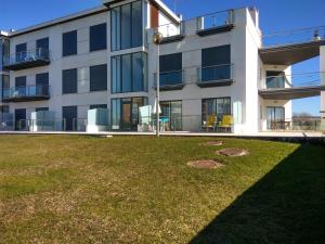 an apartment building with a lawn in front of it at Casa dos Medros in São Martinho do Porto