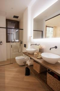 two sinks in a bathroom with a mirror and a shower at Apartamentos Cervantes in Badajoz +88 photos