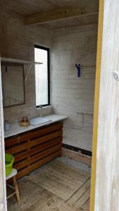 a bathroom with a sink and a mirror in a room at Mysig stuga i Rute med stor trädgård in Lärbro