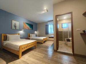 a bedroom with two beds and a bathroom at Water World Diving Resort in Green Island
