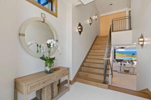 a home with a staircase and a mirror at Timbers 3003 condo in Lihue