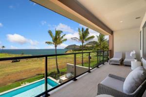 a room with a balcony with a view of the ocean at Timbers 3003 condo in Lihue