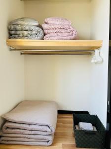 Habitación con estanterías, toallas y cesta en Warm House2 en Sapporo