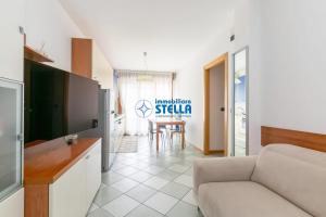 a living room with a couch and a table at Villaggio Papaia in Lido di Jesolo