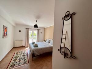 a bedroom with a bed and a mirror at Canto do Vale in Aljezur +16 photos