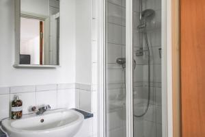 a bathroom with a sink and a shower at Modern 2-Bed in Watford Centre in Watford