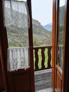 an open window with a view of a mountain at PM 10 Via Don Aldo Osquez Guest House in Antey-Saint-André
