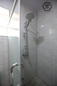 a shower with a shower head in a bathroom at Cozy Oasis Large Apt in Center of Kigali Rwanda in Kigali