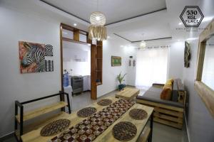 a living room with a couch and a table at Cozy Oasis Large Apt in Center of Kigali Rwanda in Kigali