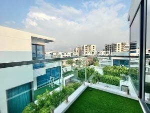 an apartment with a garden on the balcony of a building at Pupae Pool Villa Pattaya in Pattaya South