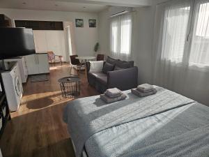 a bedroom with a bed and a living room with a couch at City Center Apartments in Paphos City
