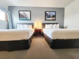 A bed or beds in a room at Days Inn & Conference Centre by Wyndham Camrose Norsemen