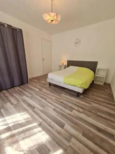 a bedroom with a bed and a wooden floor at Appartement de 2 chambres avec jardin amenage et wifi a Rosureux in Rosureux