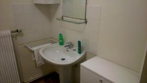 a white bathroom with a sink and a mirror at Appartement de 2 chambres avec jardin amenage et wifi a Rosureux in Rosureux