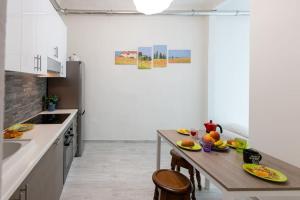 a kitchen with a wooden table and chairs in a room at Stazione - Arno River apartment in Florence