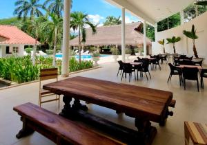 un restaurant avec des tables et des chaises ainsi qu'une piscine dans l'établissement HOTEL SANTAFE NATURA - SANTAFE DE ANTIQUIA, à Santa Fe de Antioquia