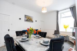 a dining room with a table and chairs at Cosy Three Bedroom Terrace Rishton in Rishton