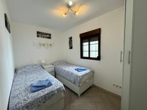 a bedroom with two beds and a window at Sea View Apartment in Manilva +7 photos