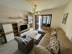a living room with a couch and a table at Sea View Apartment in Manilva