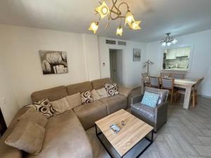 a living room with a couch and a table at Sea View Apartment in Manilva
