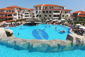 a large swimming pool in a resort with people in it at STUNNING VILLA with PRIVATE POOL in Kableshkovo