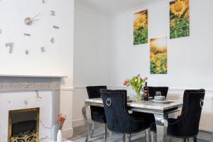 a dining room with a table and chairs and a fireplace at Cosy Three Bedroom Terrace Rishton in Rishton