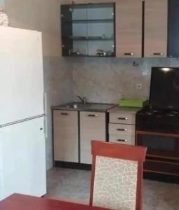 a kitchen with a white refrigerator and a sink at Žabljak Apartman in Žabljak +4 photos