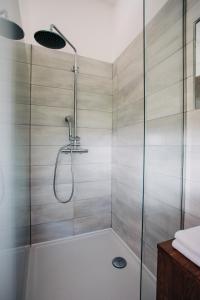 a shower stall with a glass door in a bathroom at Apartment House Blazar in Tolmin +60 photos
