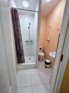 a bathroom with a shower and a toilet at Гостевой Отель-125 in Aktau