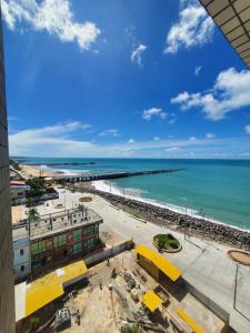 a view of the beach and the ocean from a building at Tabajara Flat 807 Com piscina in Fortaleza