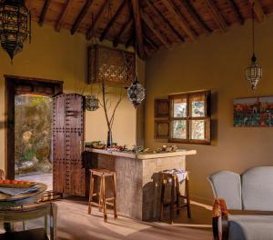 a kitchen with a bar in a room with chairs at La Fiermontina Ocean in Larache