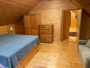 a bedroom with a bed in a wooden cabin at Chalet Hronec in Hronec