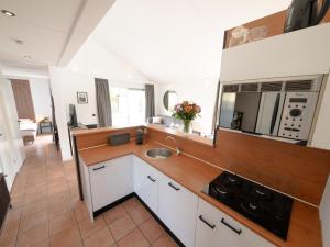 a kitchen with a sink and a counter top at Enjoy a 6-person bungalow in Zevenhuizen