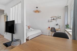 a room with a bed and a table with a television at Tranquil Retreat in the Vianden ID224 in Luxembourg