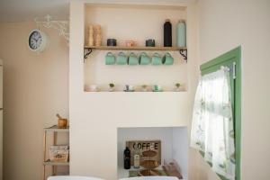 a bathroom with a toilet and shelves with bottles at La Casa a Zia in Lagoúdi Zía