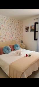 a bedroom with a bed with towels on it at CASA PERSEA in Nerja +24 photos
