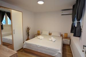 a bedroom with a bed with two towels on it at Blue Lagoon 1 in Kavala