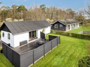 a house with a large deck in a yard at 6 person holiday home in B rkop in Børkop