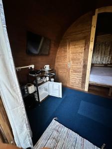 an inside view of a room with a bed and a table at Woodland camping pod with use of campsite bathroom in Grantham