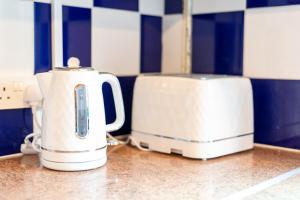 two toasters sitting on a counter in a kitchen at GuestReady - 4BR Home in Surrey Quays Canada Water in London