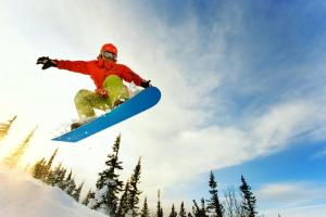a man flying through the air while riding a snowboard at Chalet BERGgrün Willingen in Willingen
