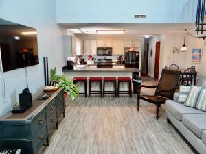 a living room with a couch and a kitchen at 35B GCR Everything Zen A Quiet Escape in Myrtle Beach