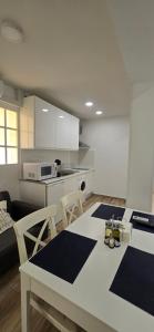 a kitchen with a table and chairs in a room at 2 bedrooms, Las Plumas in Torremolinos