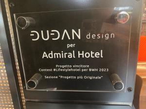 a sign for an animal hotel on a machine at Admiral Hotel in Milan