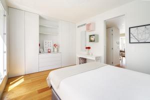 a white bedroom with a bed and a fireplace at WHome Top Floor w Luxury Design Premium Location in Lisbon
