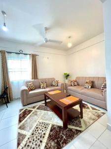 a living room with a couch and a coffee table at Pazuri Homes 2BD Apartment in Mombasa