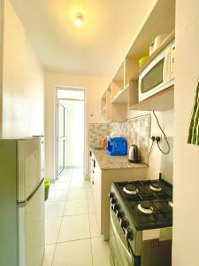 a kitchen with a stove and a counter top at Pazuri Homes 2BD Apartment in Mombasa