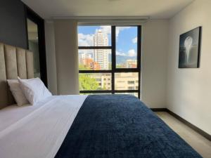 En eller flere senge i et værelse på 1201 Luxury Excelente ubicación + 26 billeder