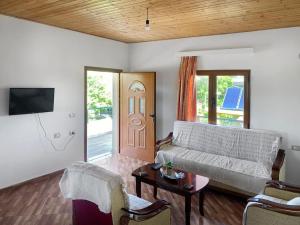a living room with a couch and a door at Ron Guesthouse 1 in Lezhë
