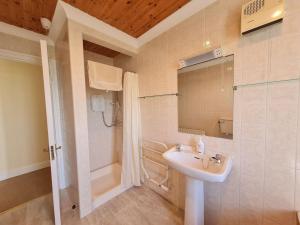 a bathroom with a sink and a shower at Sea View Cottage, Errislannan in Ballyconneely